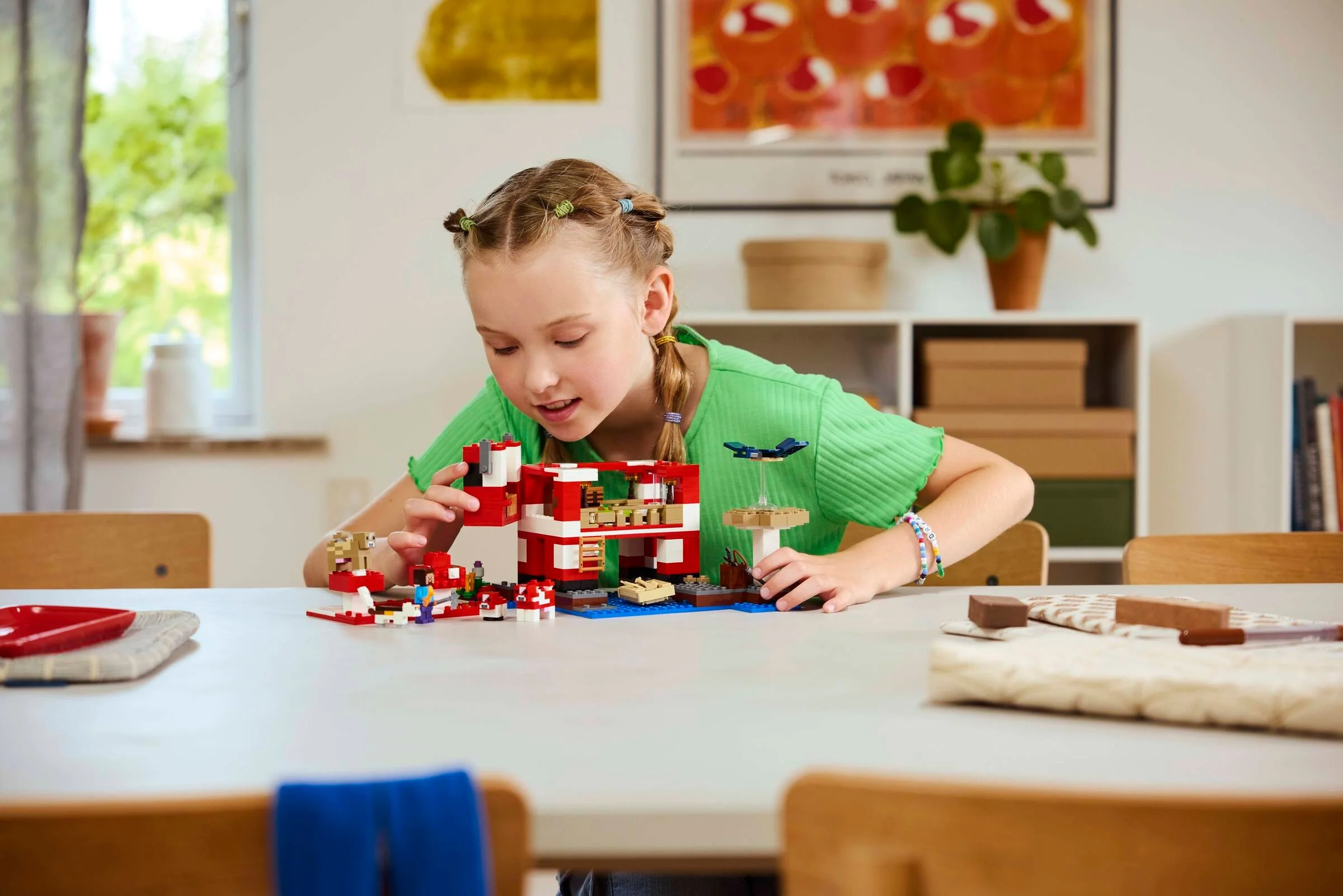 Fetiță construind casa Mooshroom LEGO Minecraft. Scene realiste, captivante.