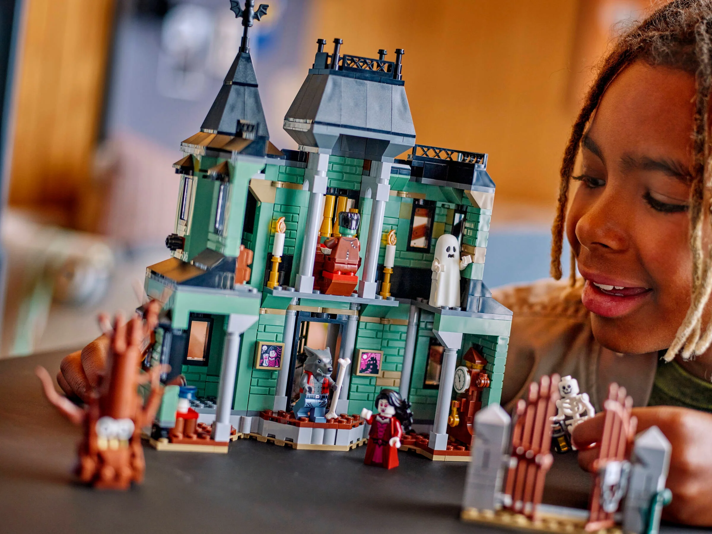 Copil admirând Castelul Bântuit LEGO Creator 31167. Un model plin de detalii și minifigurine.
