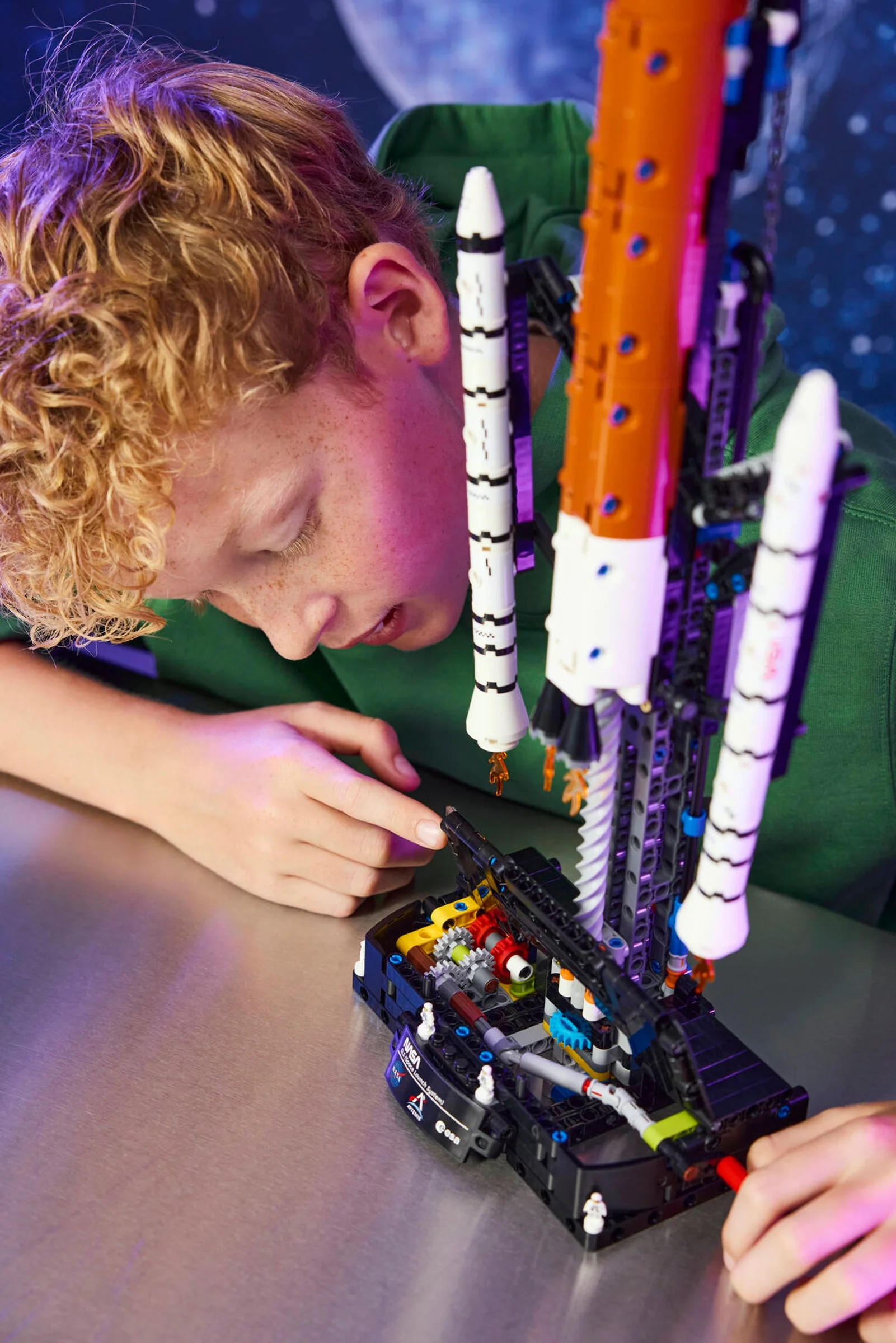 Băiat construind racheta NASA Artemis Space Launch System LEGO Technic.