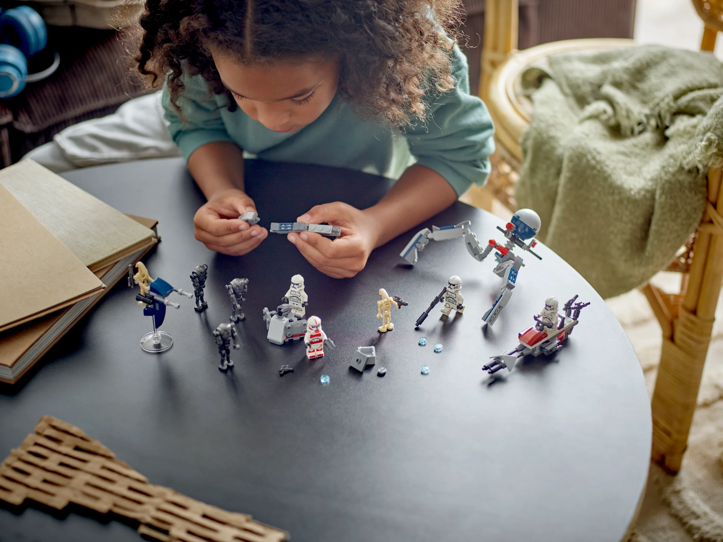 Fetiță construind setul LEGO Star Wars 75372, soldați clona și droizi de luptă.