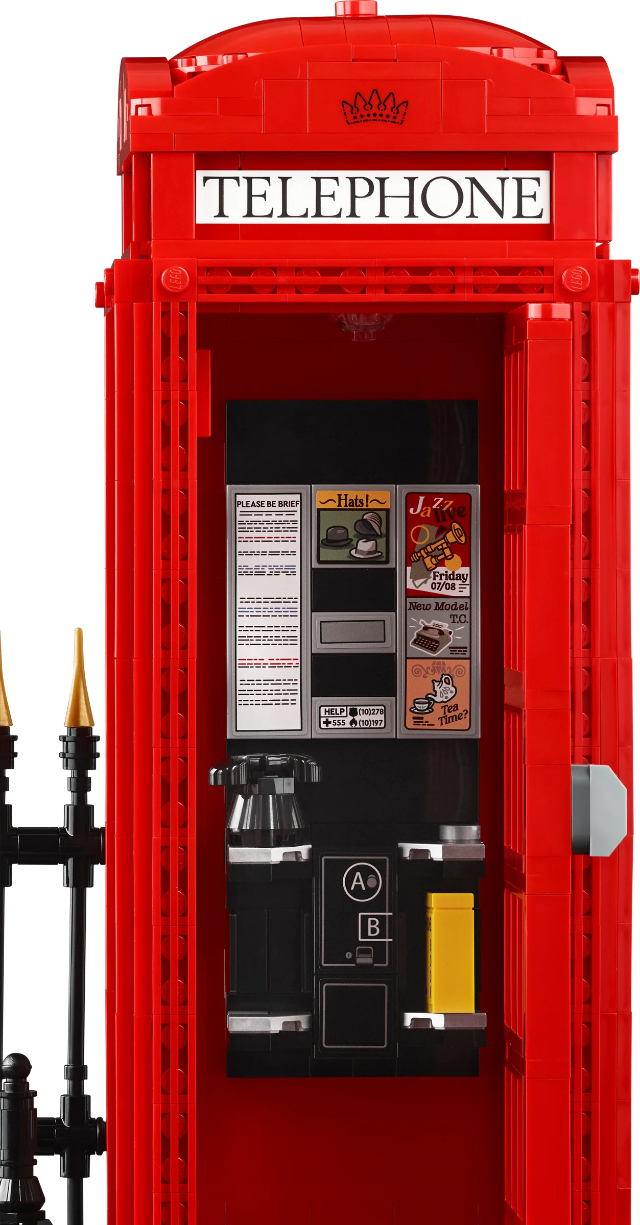 Prim-plan detaliat al interiorului cabinei telefonice roșii LEGO, cu panoul de anunțuri și telefonul.