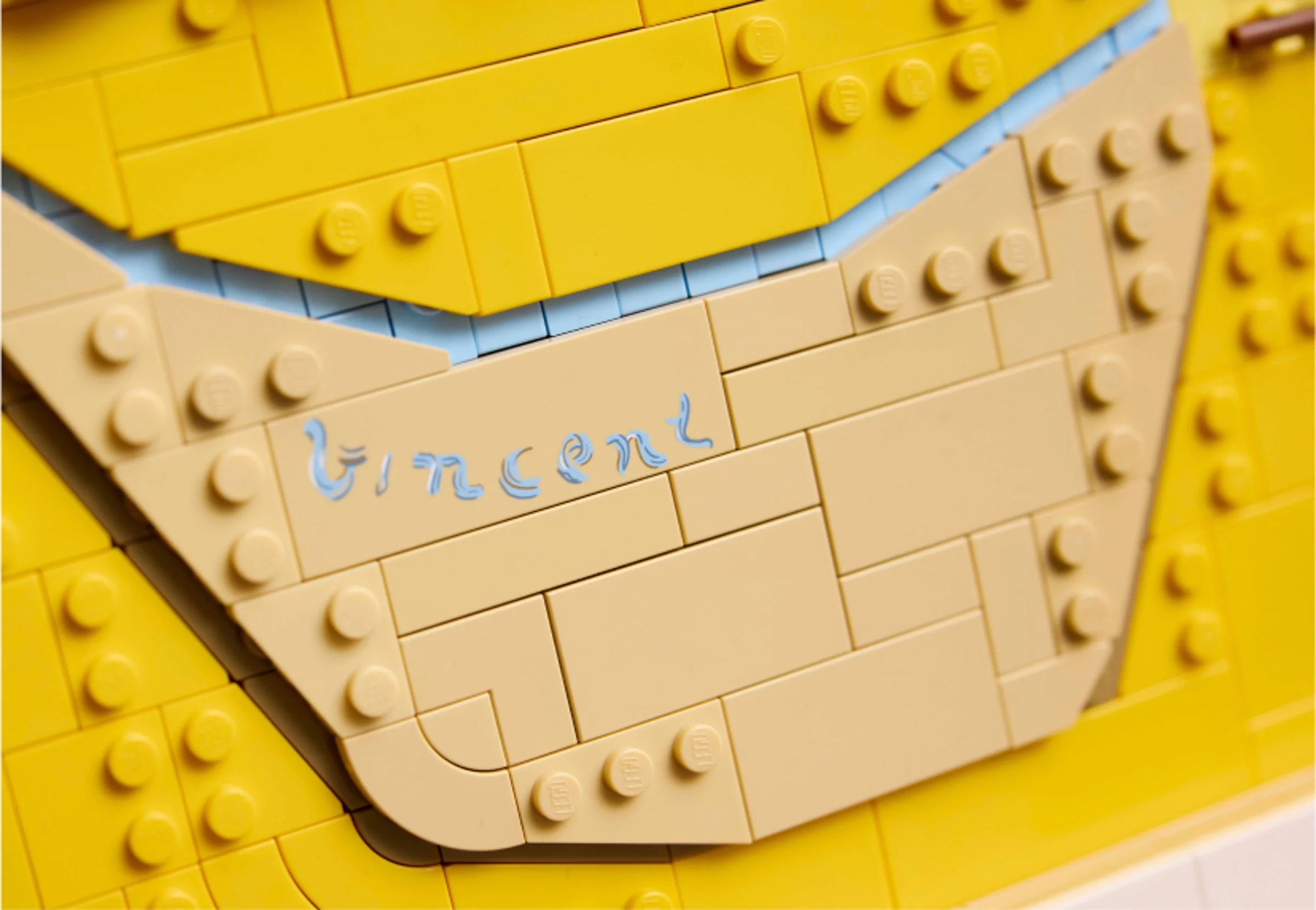 Detaliu cu numele „Vincent” scris din cărămizi LEGO pe modelul „Floarea-soarelui”.