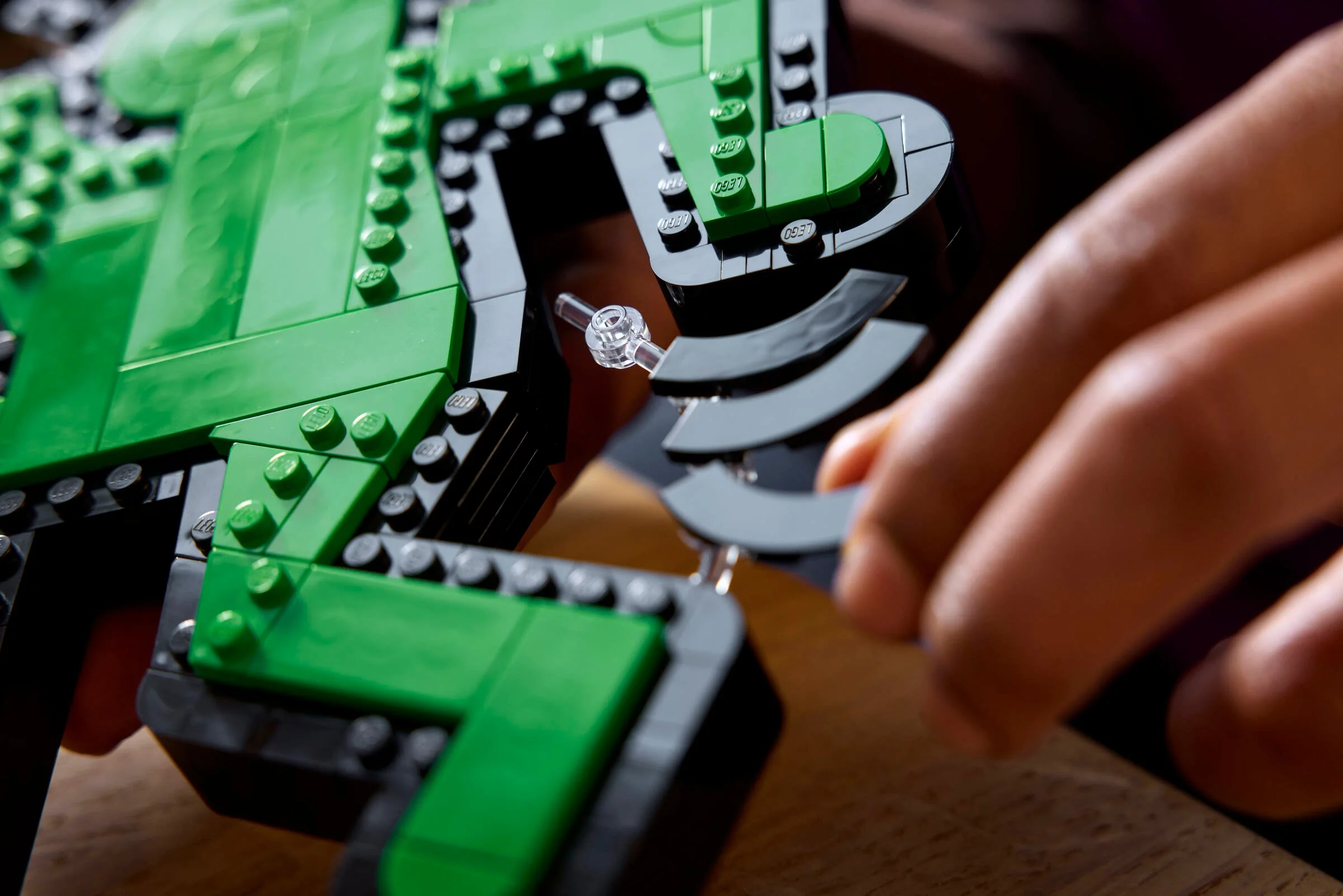 Detalii despre construcția unei figuri LEGO Keith Haring, cu accent pe îmbinări și piese.