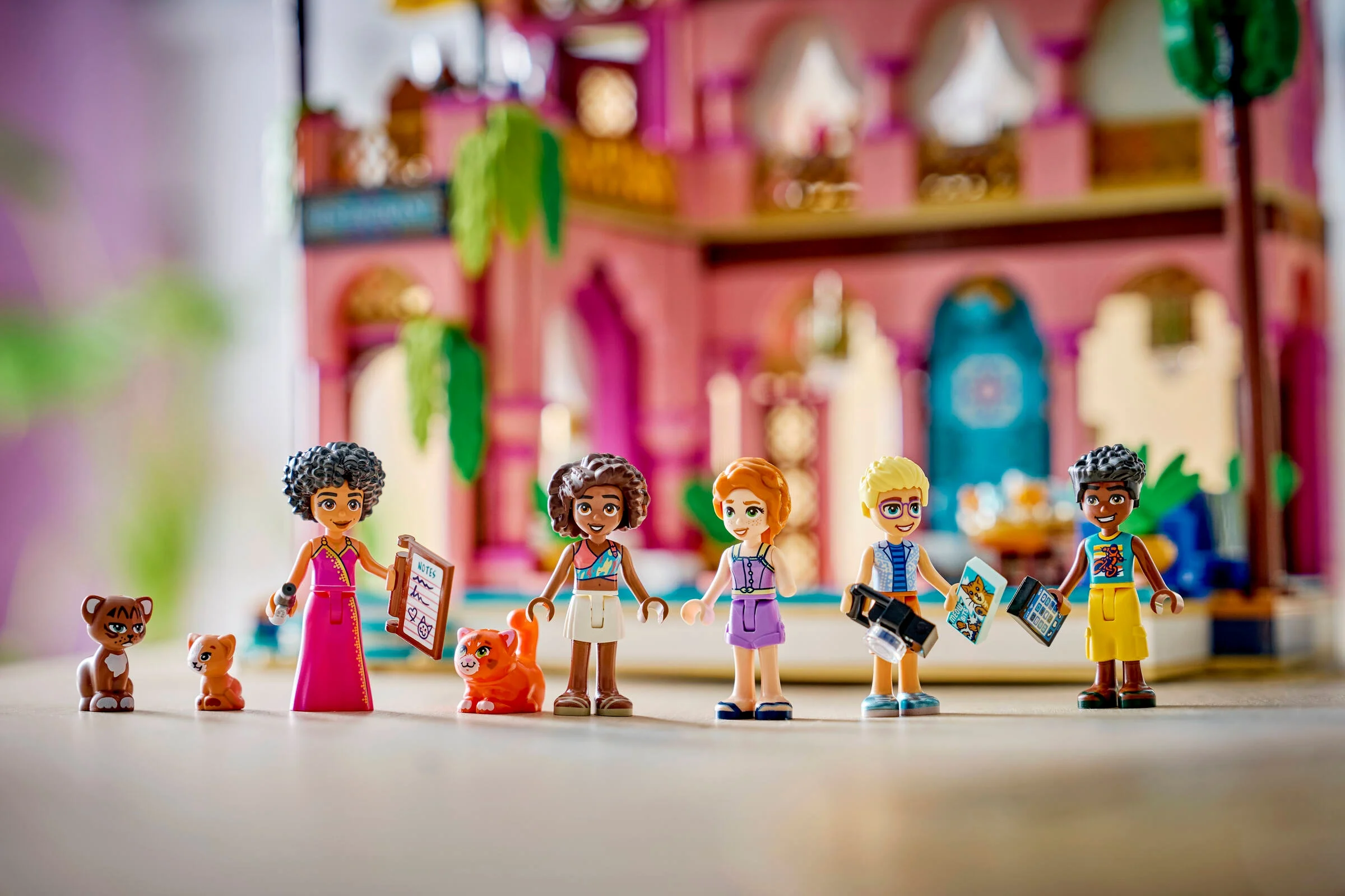 Imagine cu minifigurinele și animalele LEGO Friends în fața restaurantului. Detaliu simpatic!
