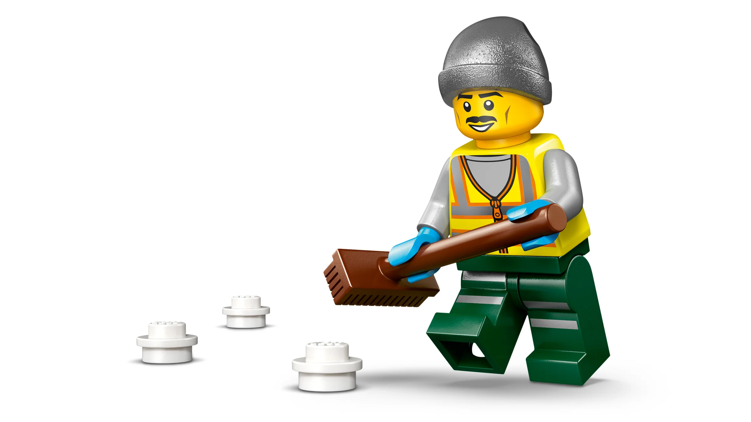 Prim-plan cu minifigurina LEGO a unui lucrător deszăpezind cu o mătură.