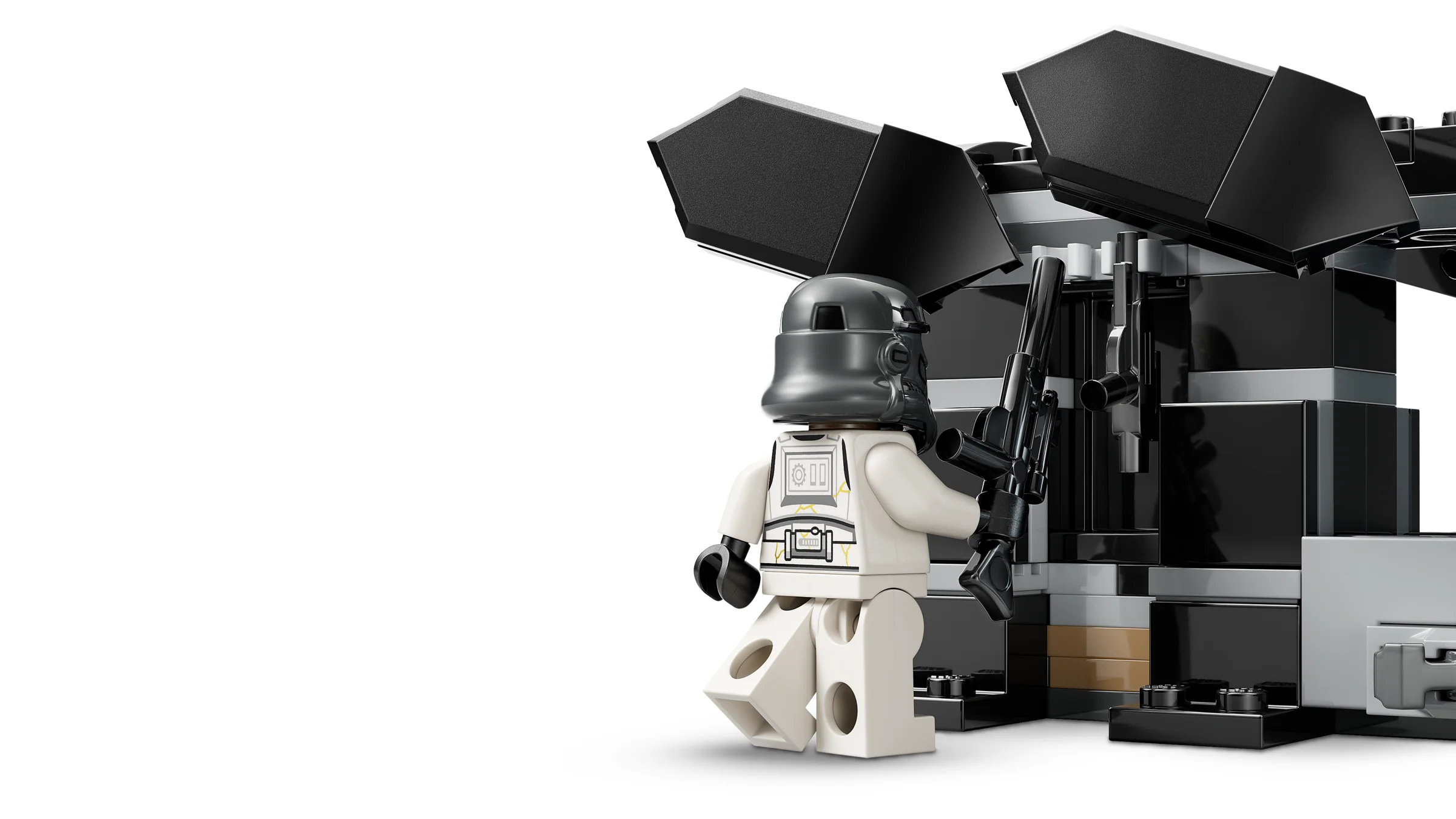 Un Night Trooper LEGO cu blaster lângă o structură neagră misterioasă.