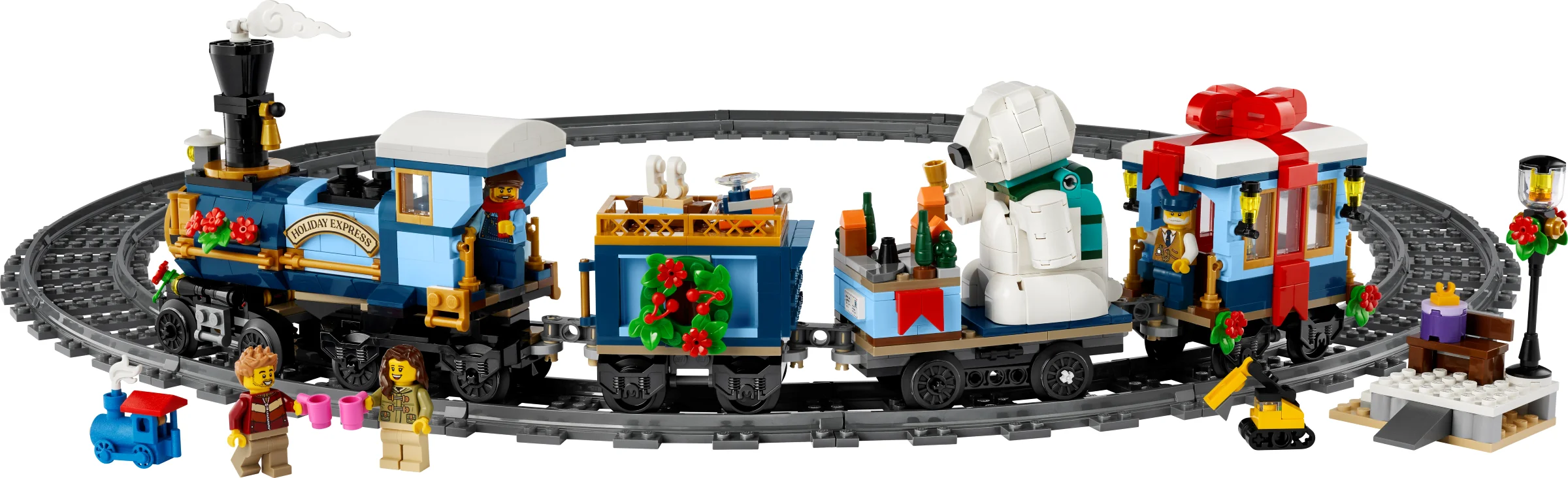Trenulețul Holiday Express 10361 LEGO, cu vagonul cadou, urs polar și minifigurine vesele.