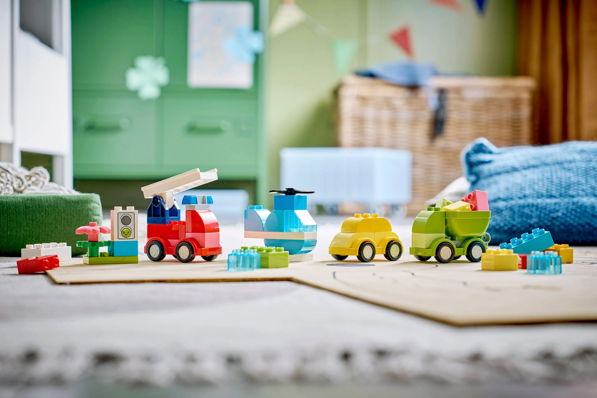 Imagine cu modelele LEGO Duplo 10474: mașină de pompieri, elicopter, mașină galbenă și camion verde.