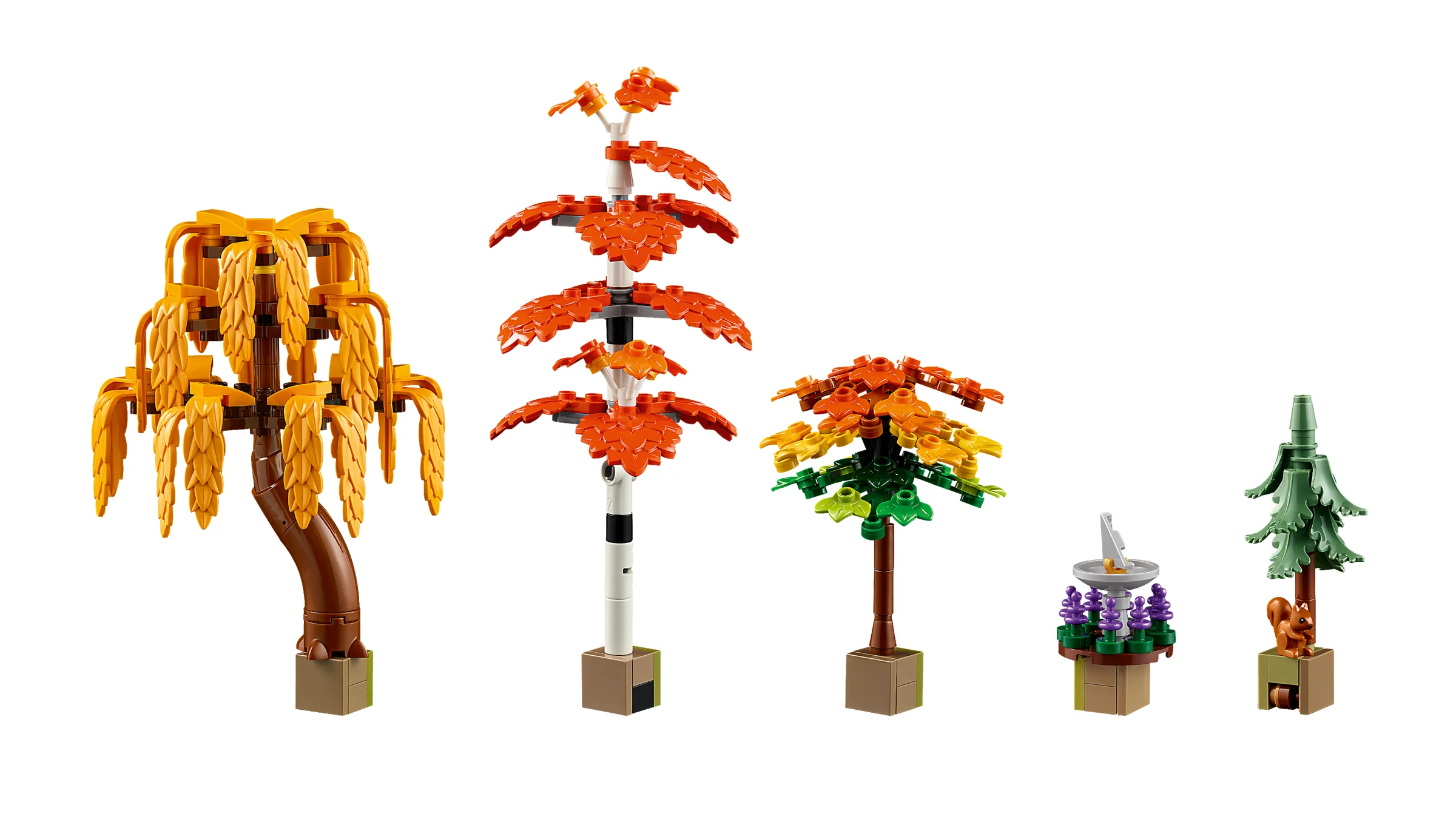 Setul LEGO prezintă diverse plante de toamnă, inclusiv copaci cu frunze galbene și portocalii.