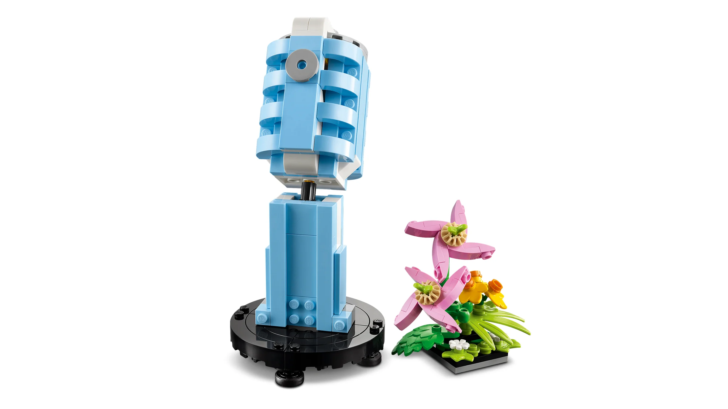 O imagine a modelului LEGO 31172 cu un pick-up albastru și flori colorate.