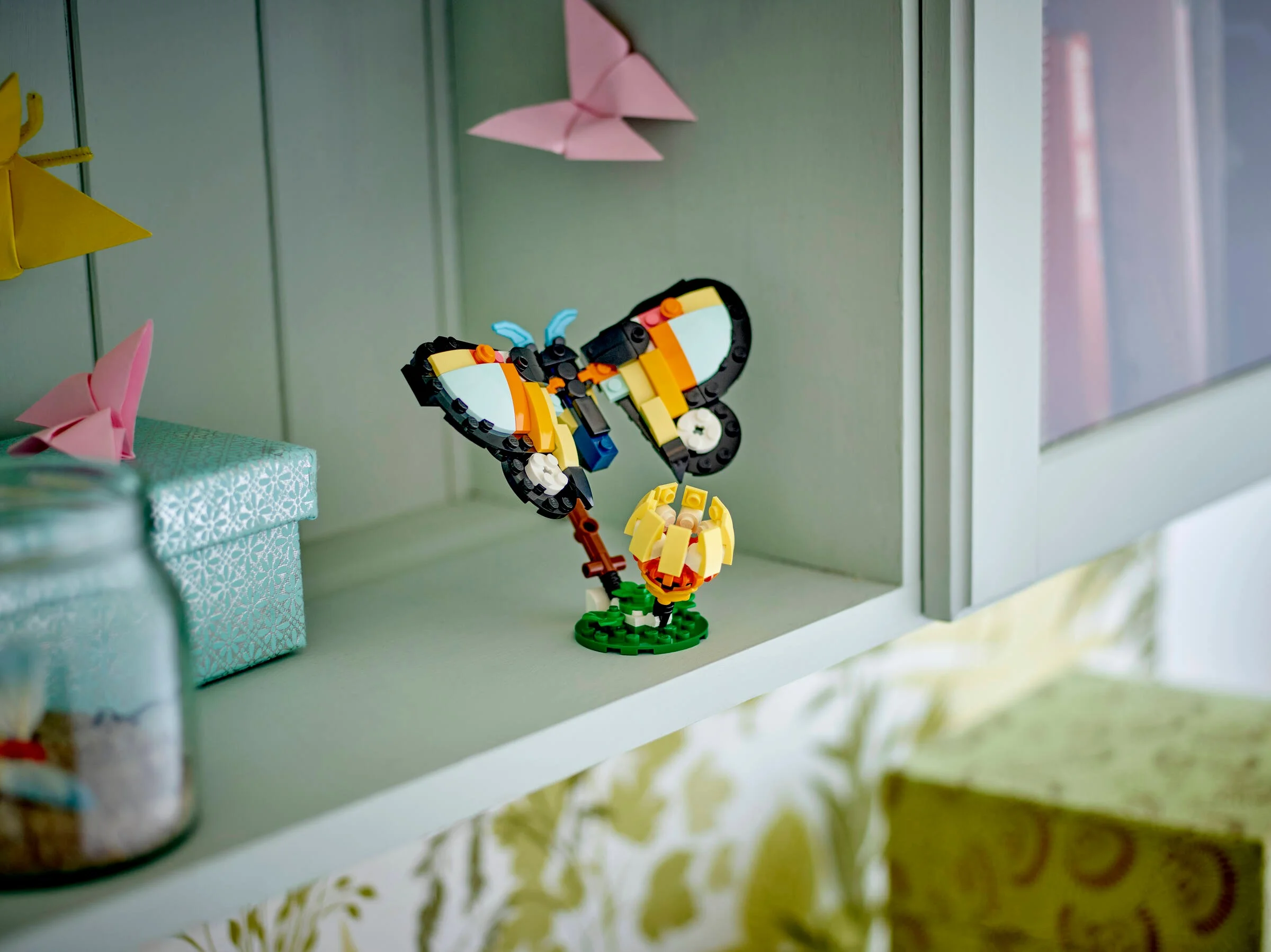 Un model Creator 3-în-1 cu un fluture LEGO colorat pe o floare.