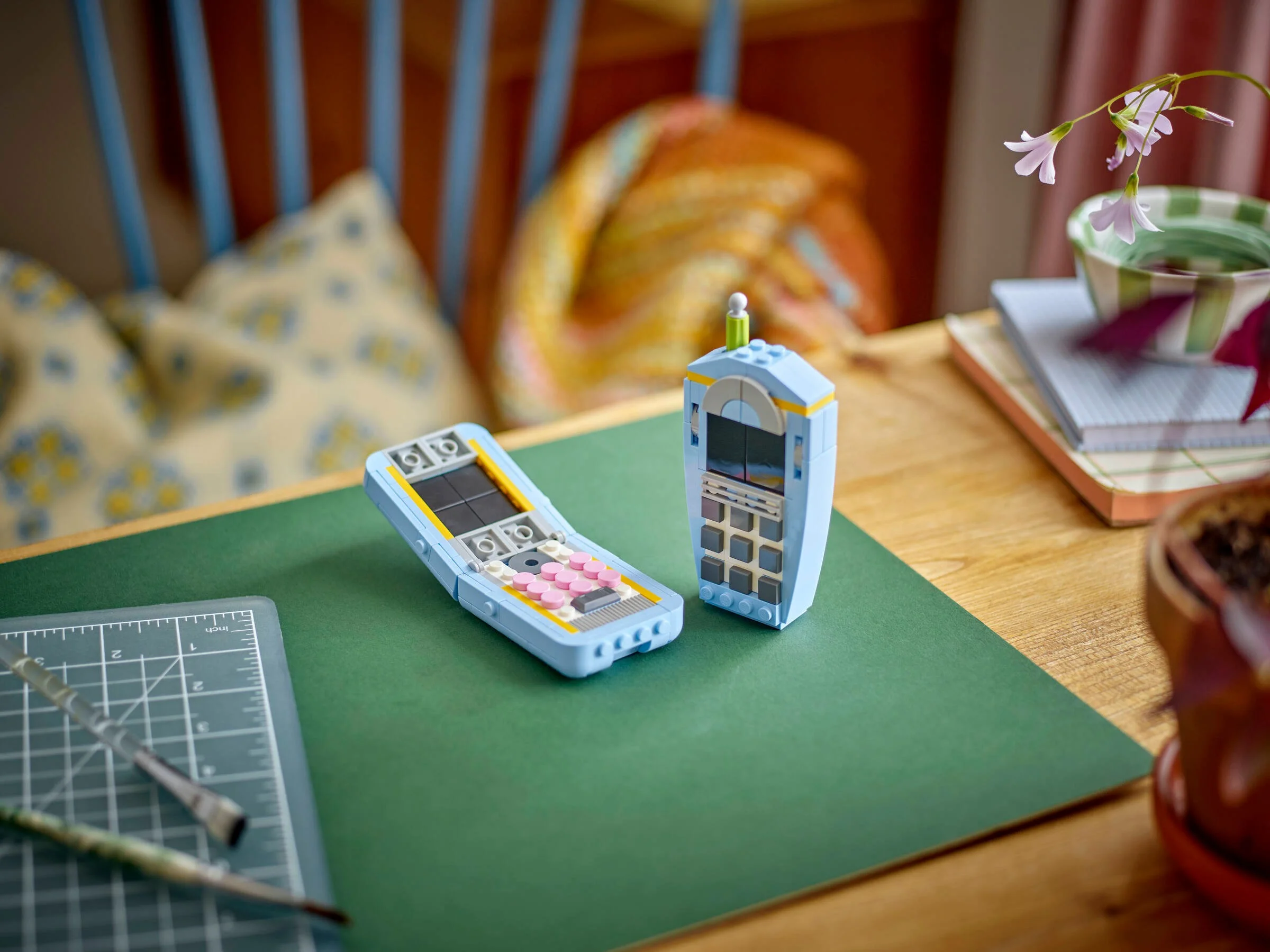 Imagine cu două modele de telefoane LEGO retro, albastre și gri.