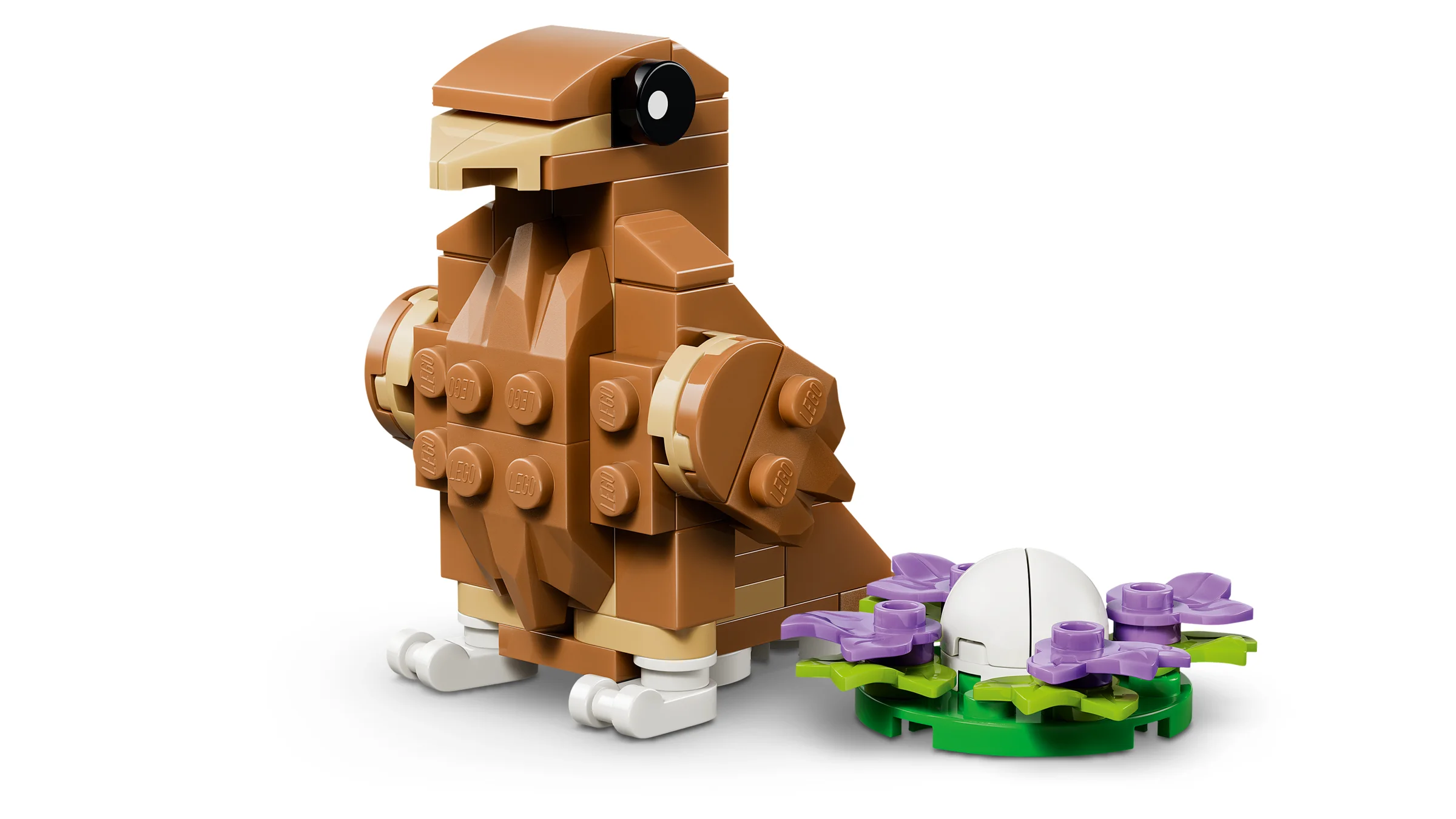 Imagine cu un hamster drăguț construit din LEGO, lângă o floare. Setul LEGO Creator 31376.