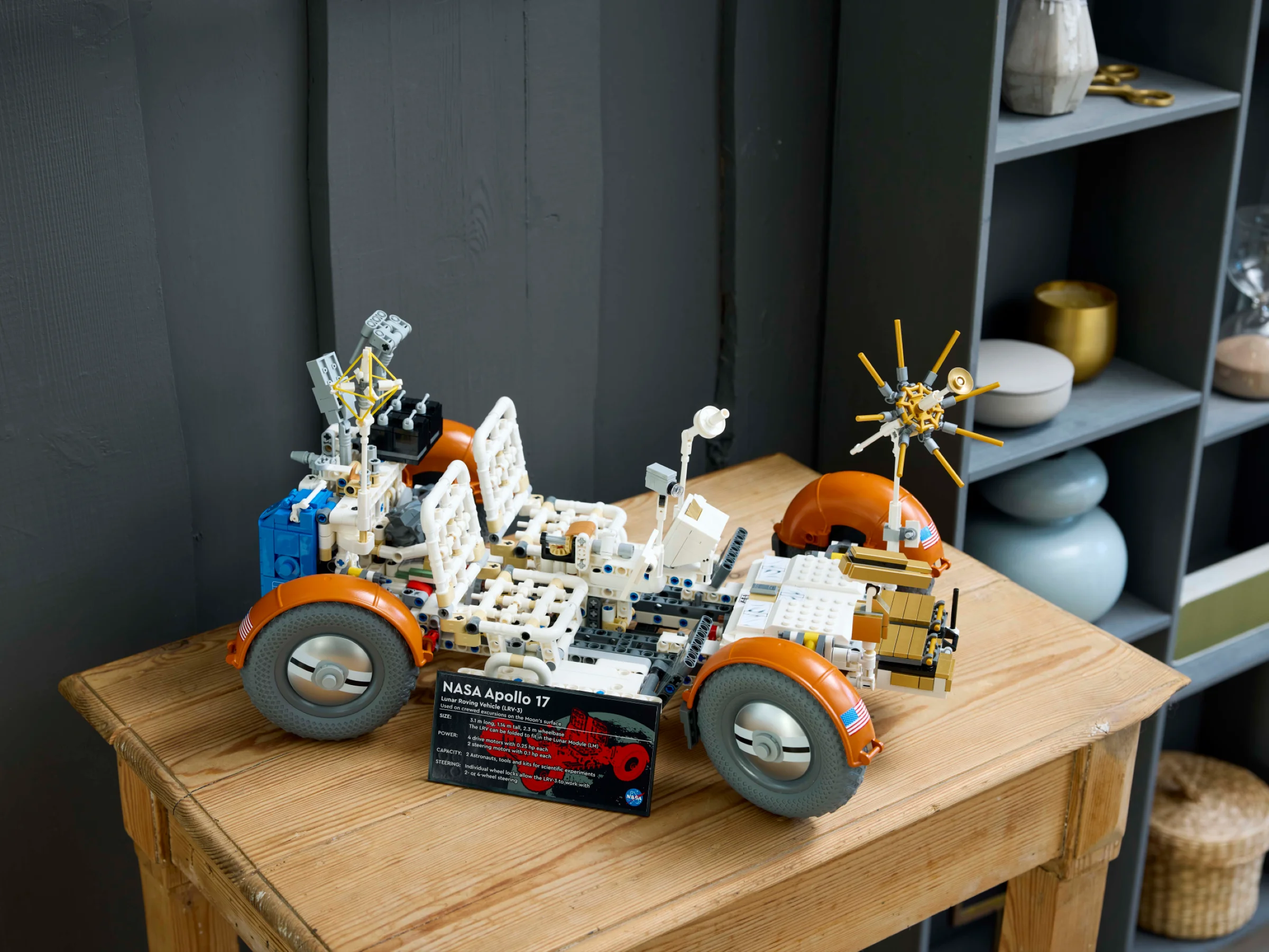Modelul LEGO 42182 LRV Apollo 17, cu detaliile sale tehnice expuse pe o masă de lemn.