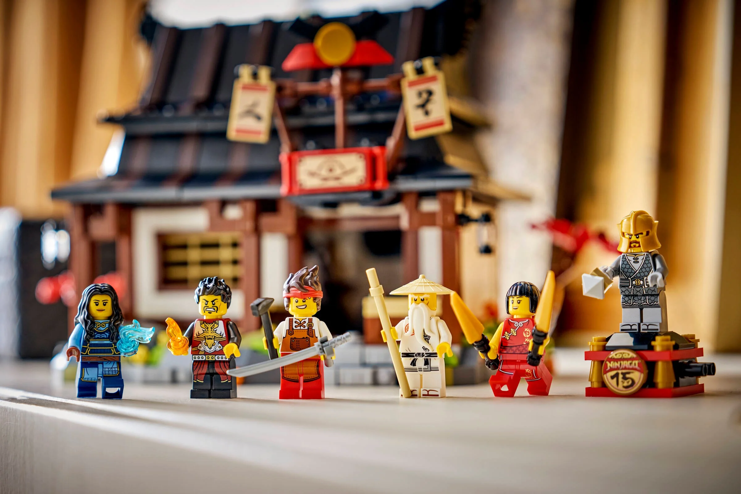 Imagine cu setul LEGO Ninjago 71858, cu minifigurinele și clădirea fierăriei.