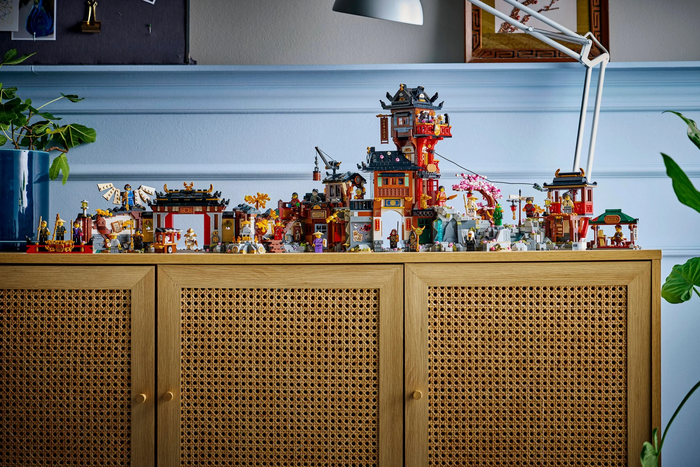 O imagine completă a setului LEGO 71861 Vechiul Oraș Ninjago, așezat pe o comodă. E o scenă detaliată.