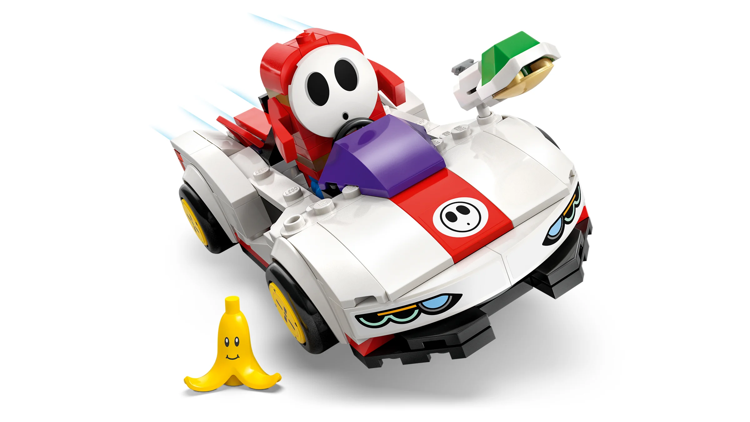 Shy Guy și P-Wing LEGO. O mașină albă cu dungă roșie și minifigurina Shy Guy. O banană e la pământ.