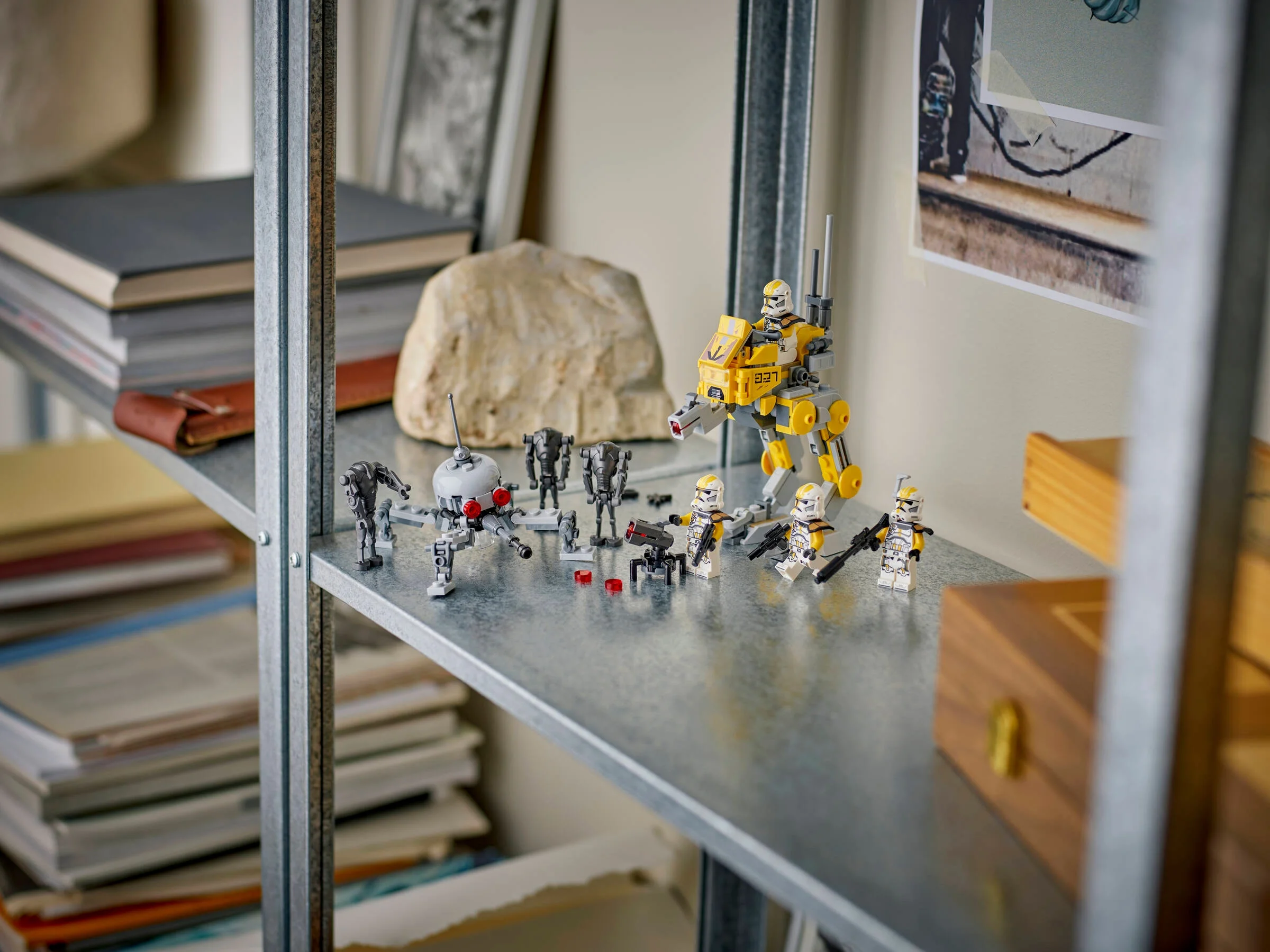 Prezentare cu soldați clona 327th Star Corps, droidi și un walker AT-RT pe un raft metalic.