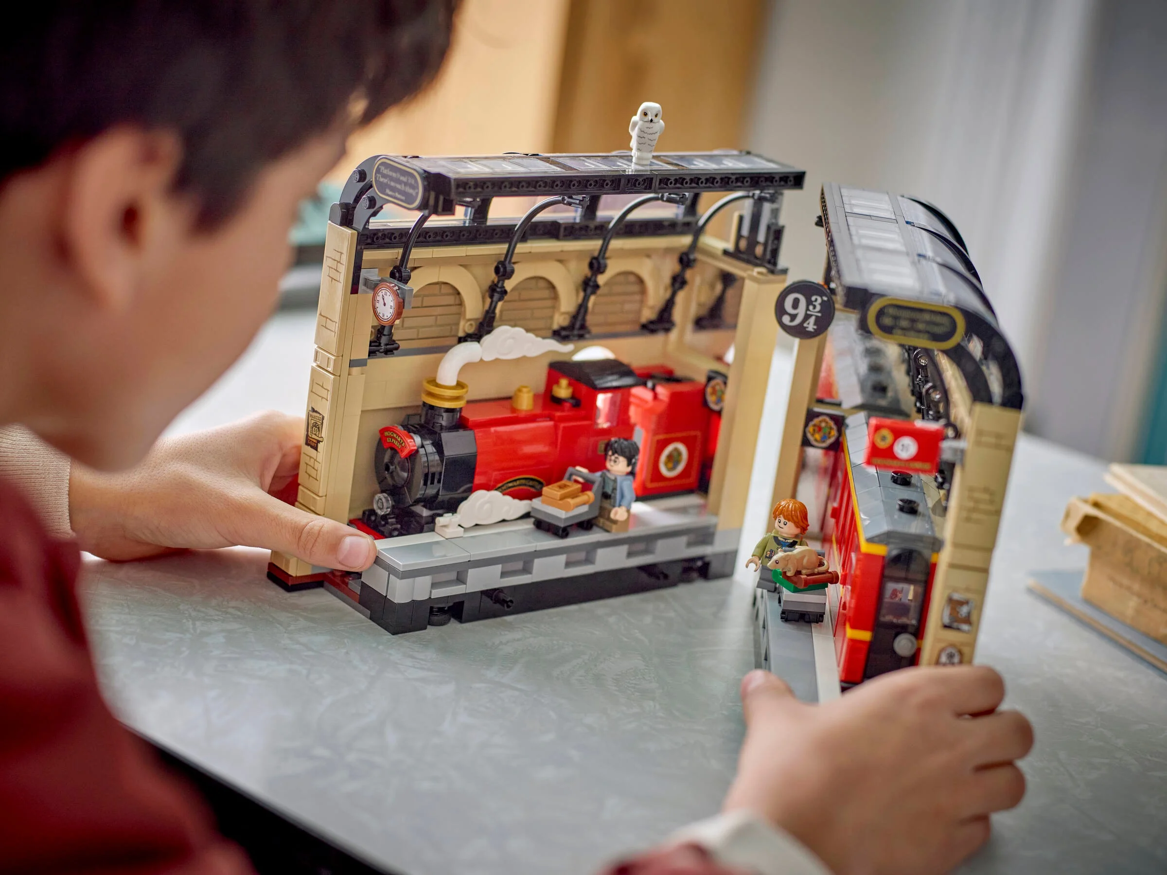 Prezentare detaliată a setului LEGO Hogwarts Express sub forma unui colț de carte.