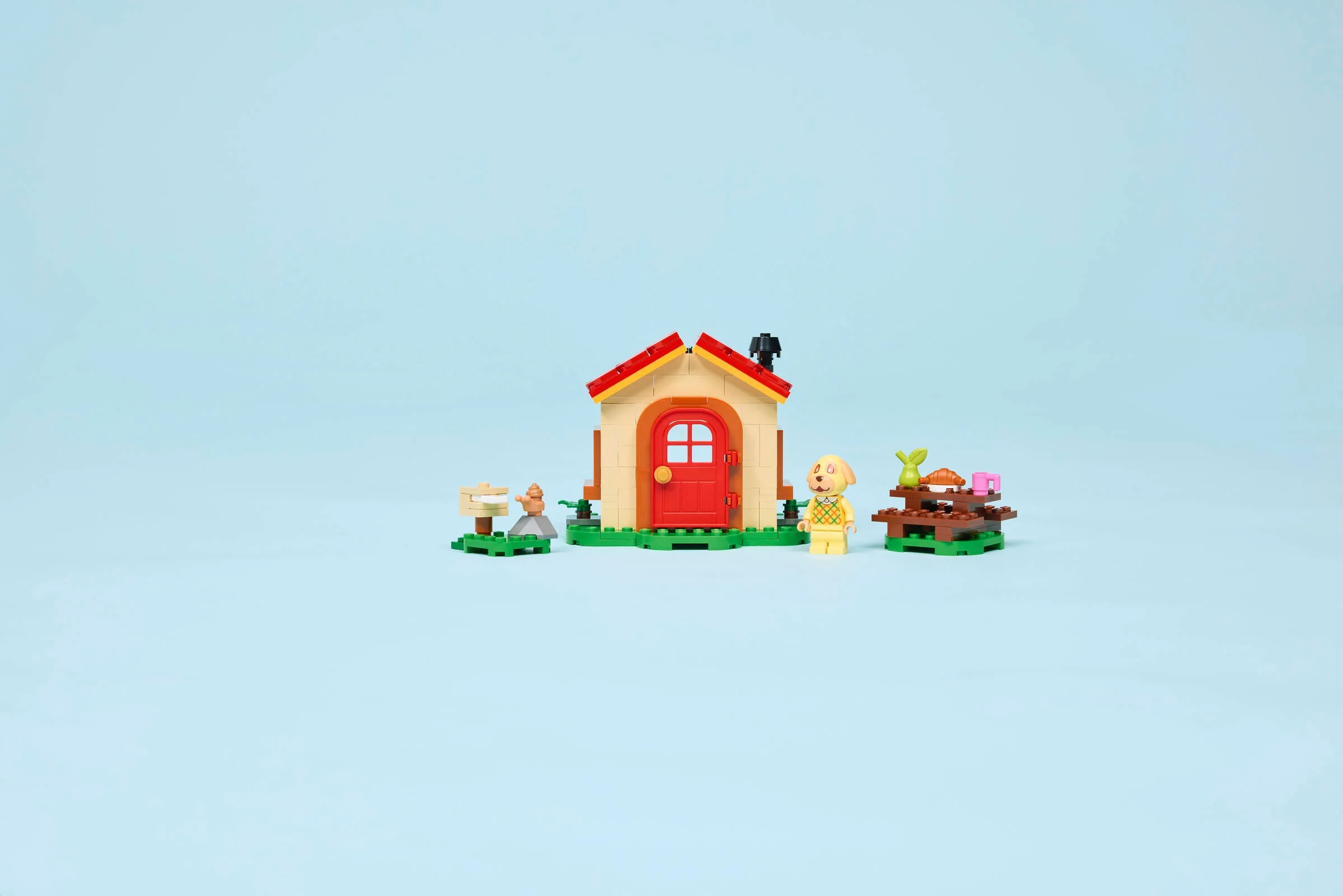 Imagine cu setul LEGO 77058 Goldie's Cosy House, cu căsuță, minifigurină și mobilier.