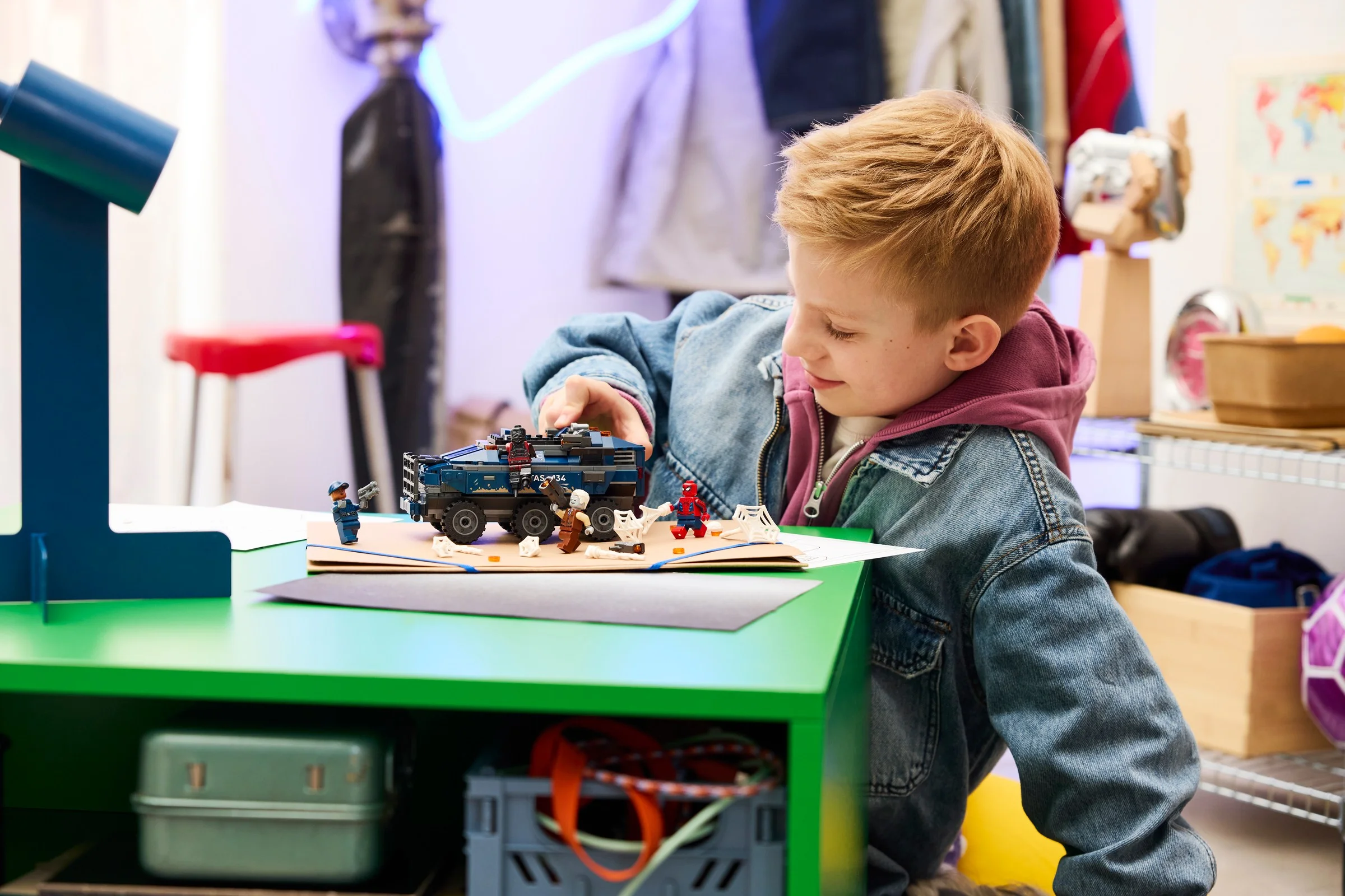 Copil se joacă cu setul LEGO Spider-Man Prison Transport Chase (76349).
