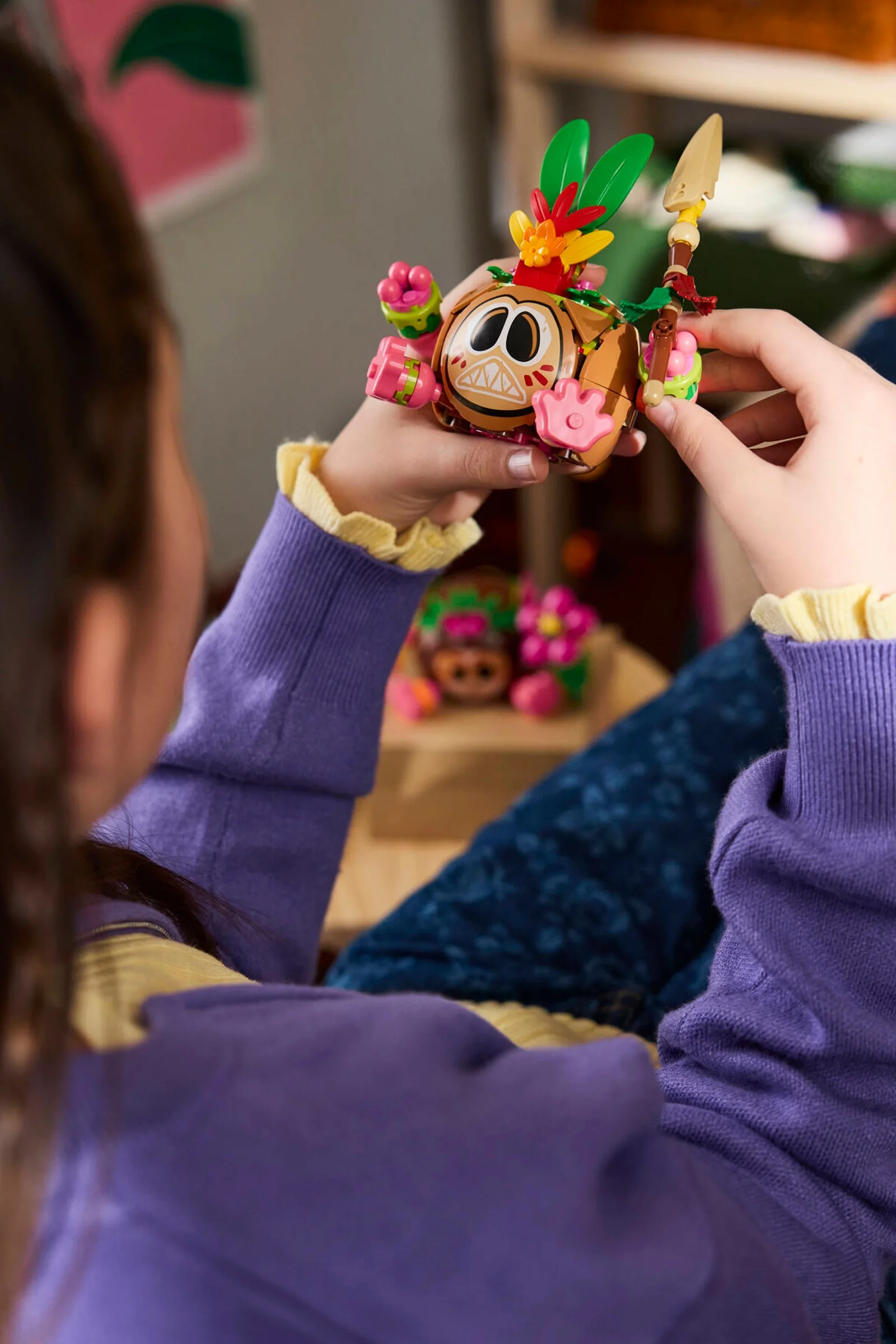 O persoană ține în mână un Kakamora LEGO construit. Focus pe detalii și aspectul general.