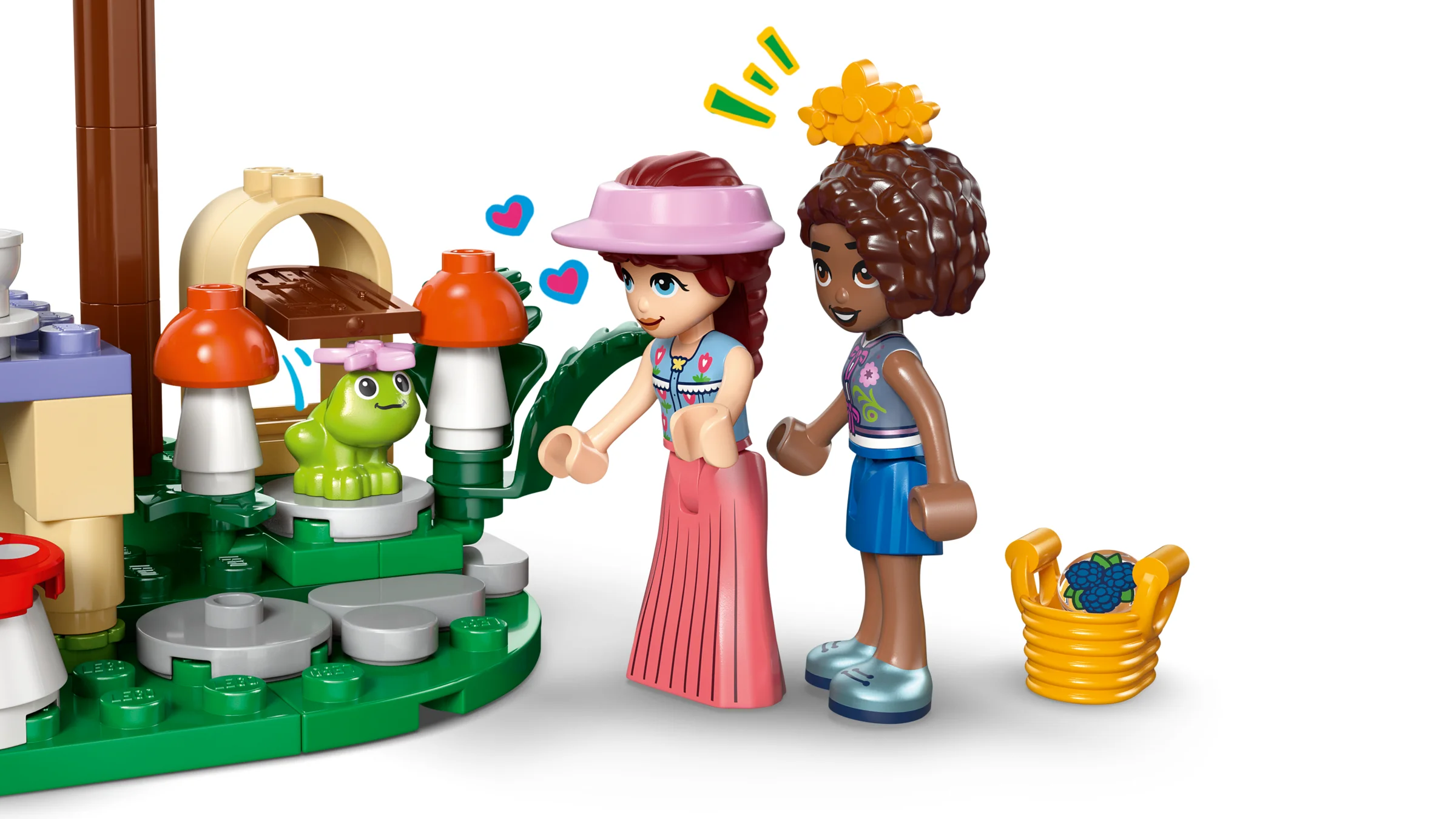 Două minifigurine Friends se bucură de o petrecere a ceaiului în pădure cu o broască drăguță.