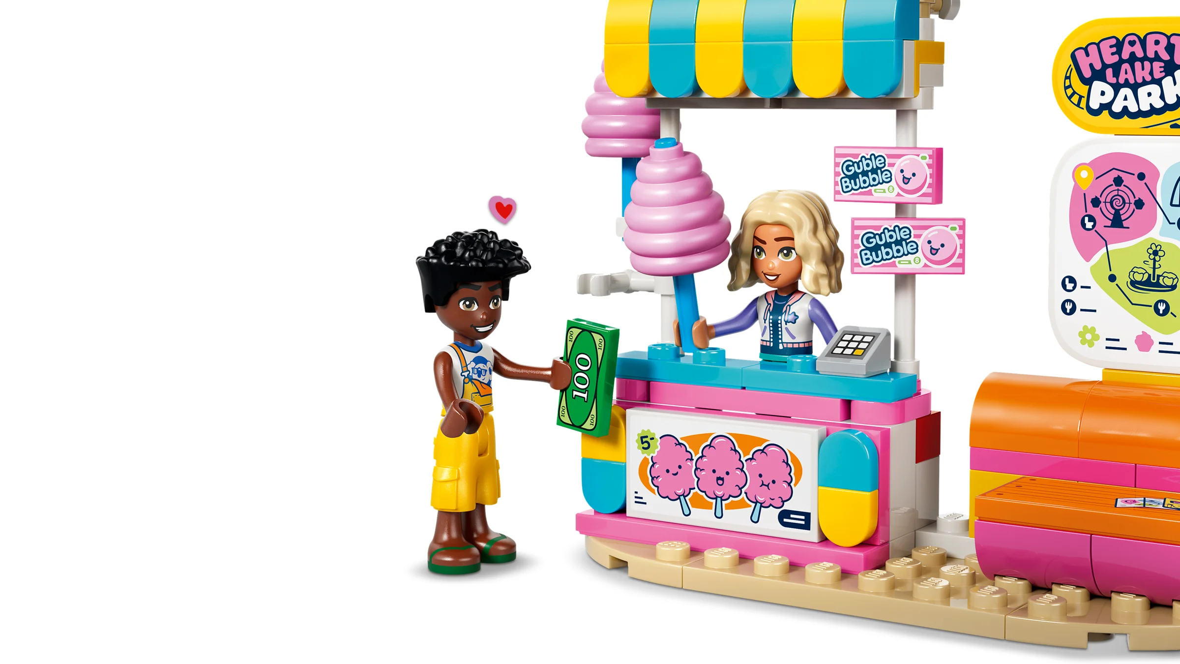 Imagine cu taraba de dulciuri și minifigurinele LEGO Friends interacționând. Detaliu din setul 42700.