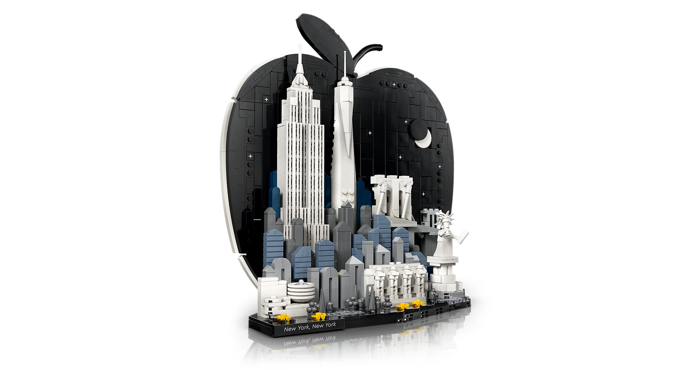 Modelul LEGO al skyline-ului New York, încadrat într-un măr negru. Elemente iconice redate fidel.
